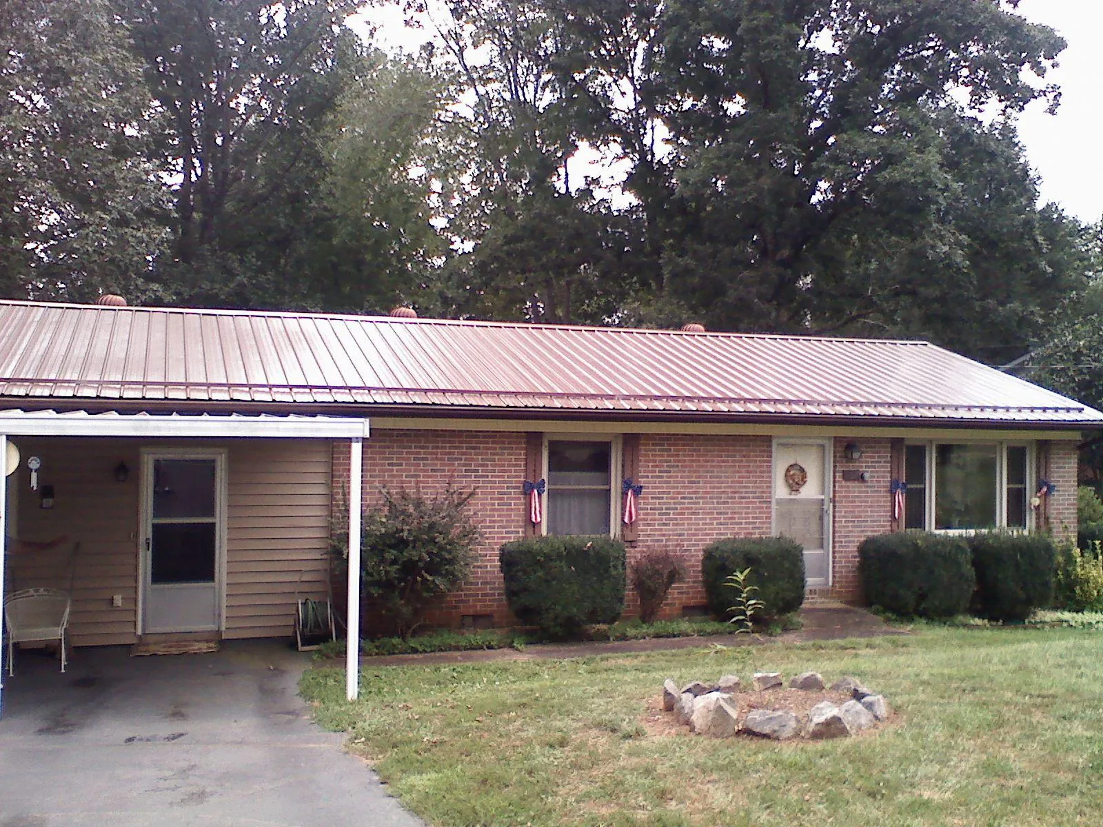 Bronze metal roof and carport on a brick ranch home — Roof Repair work by our crew in Ashfield