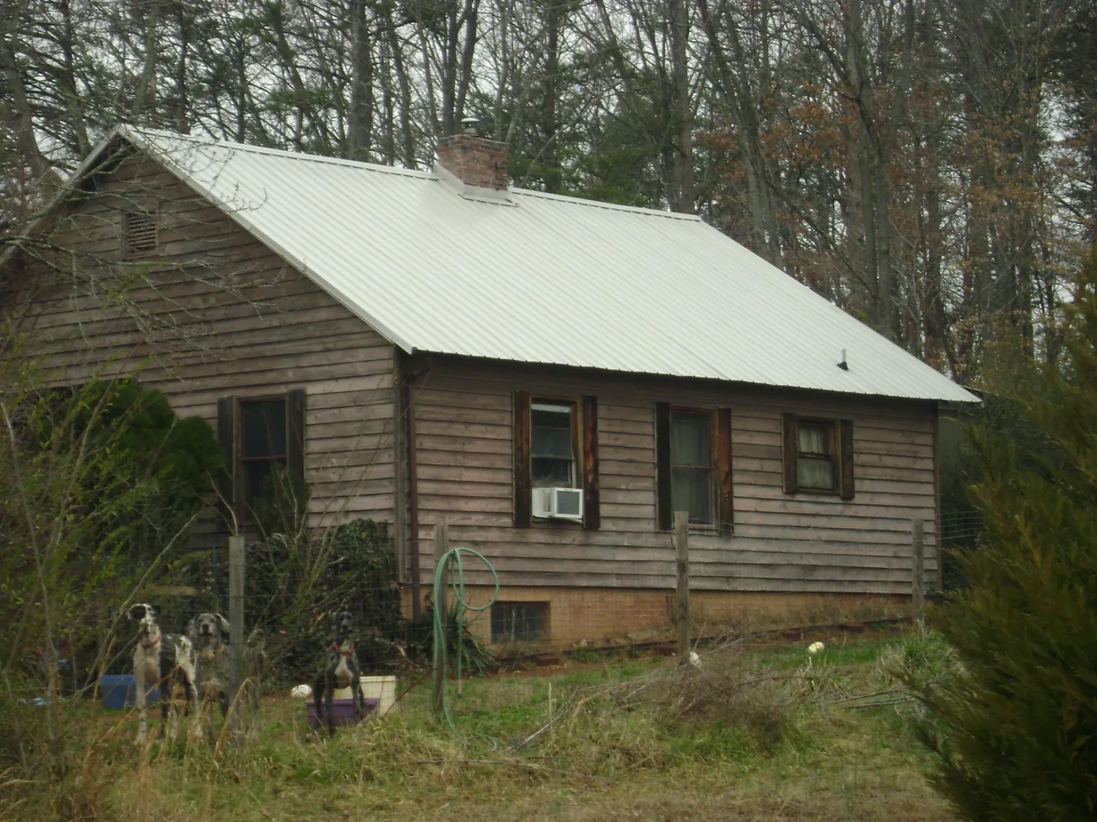 White metal roof on an old wood sided farmhouse, from a Metal Roof Installation job in Ashfield